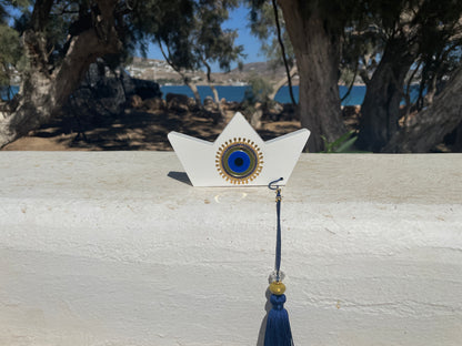 Decorative item with a star-shaped base and blue tassel on a wooden surface.