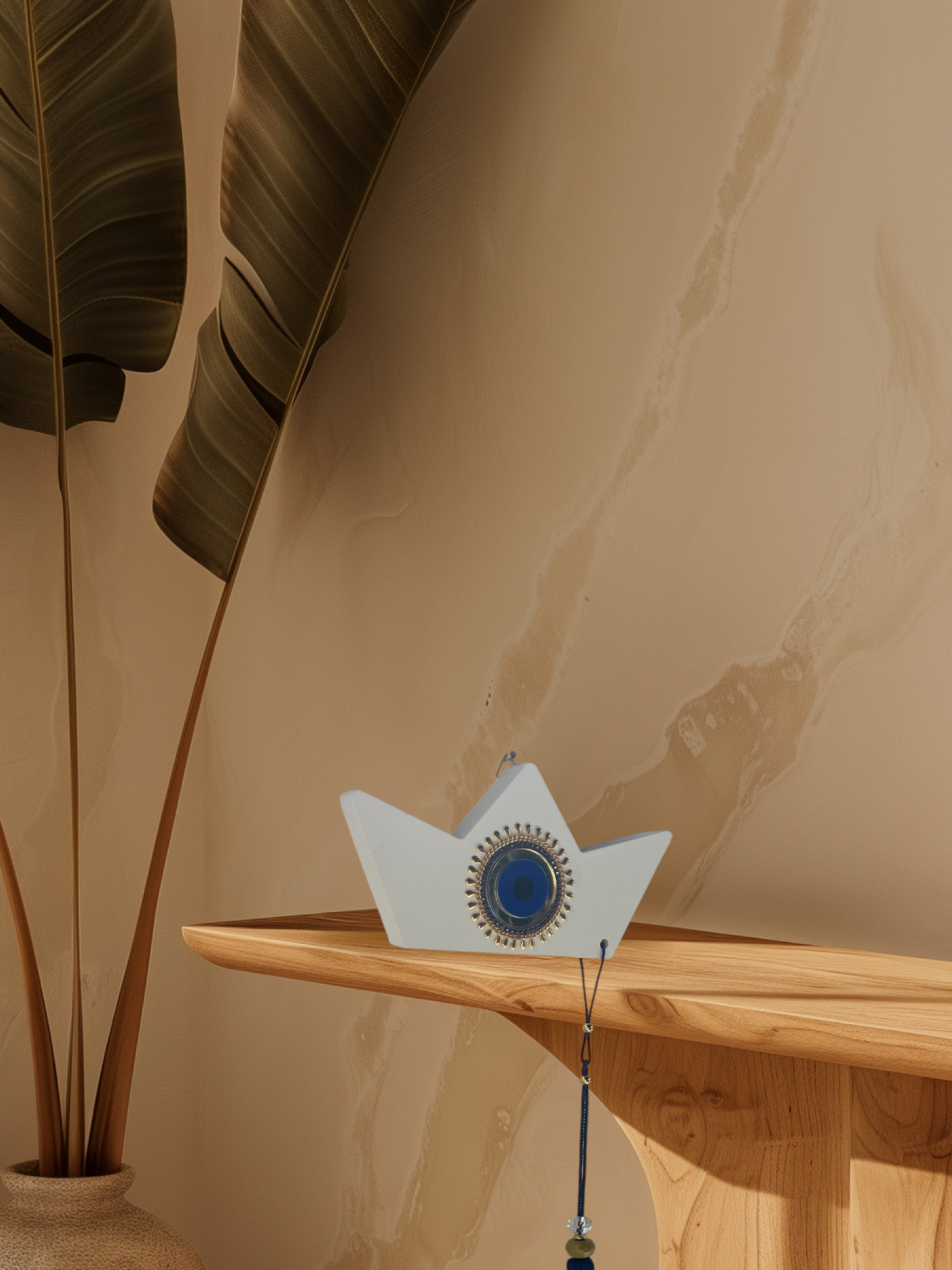 Decorative object on a wooden shelf with a plant in the background