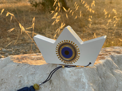 Decorative object with a circular design on a stone surface with grass in the background